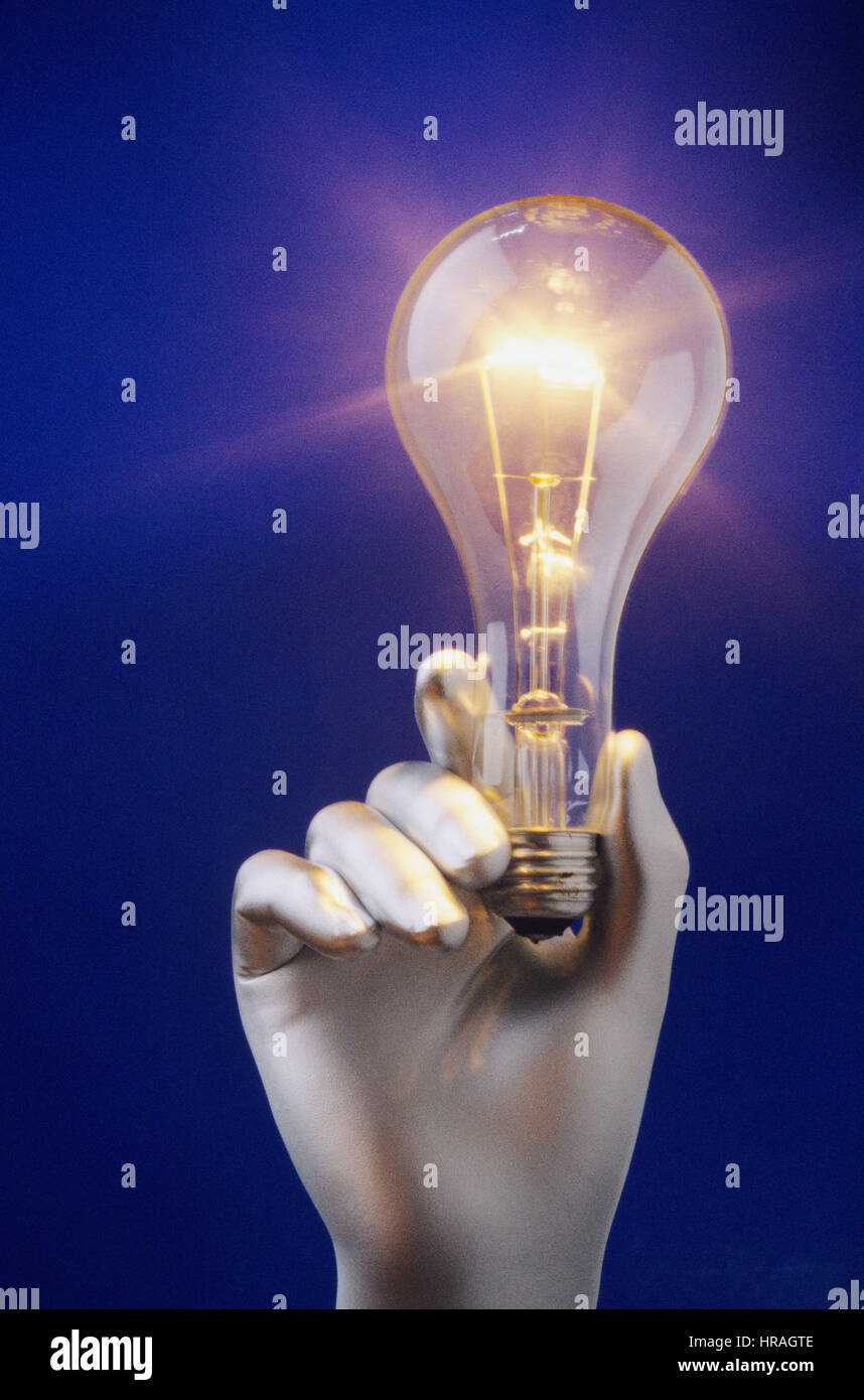 Silver hand holding glowing light bulb Stock Photo - Alamy
