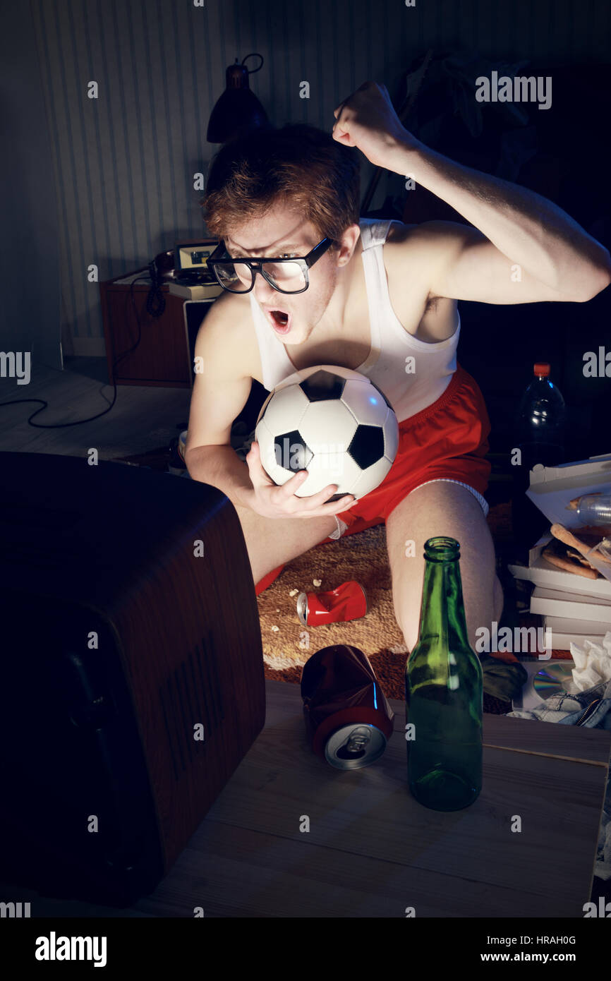Nerd boy excited by goal scored during sports competition Stock Photo