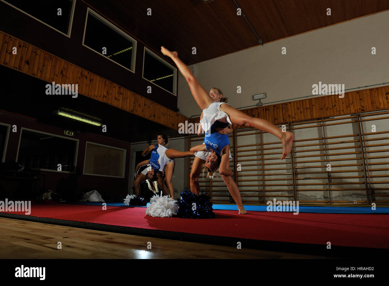 Young cheerleaders team training in the gym Stock Photo - Alamy