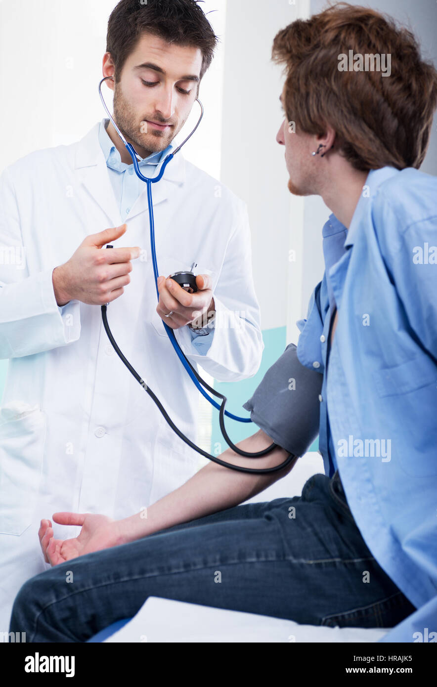 Doctor Using Measuring Tools Doctor measuring blood pressure with specific medical equipment Stock ...