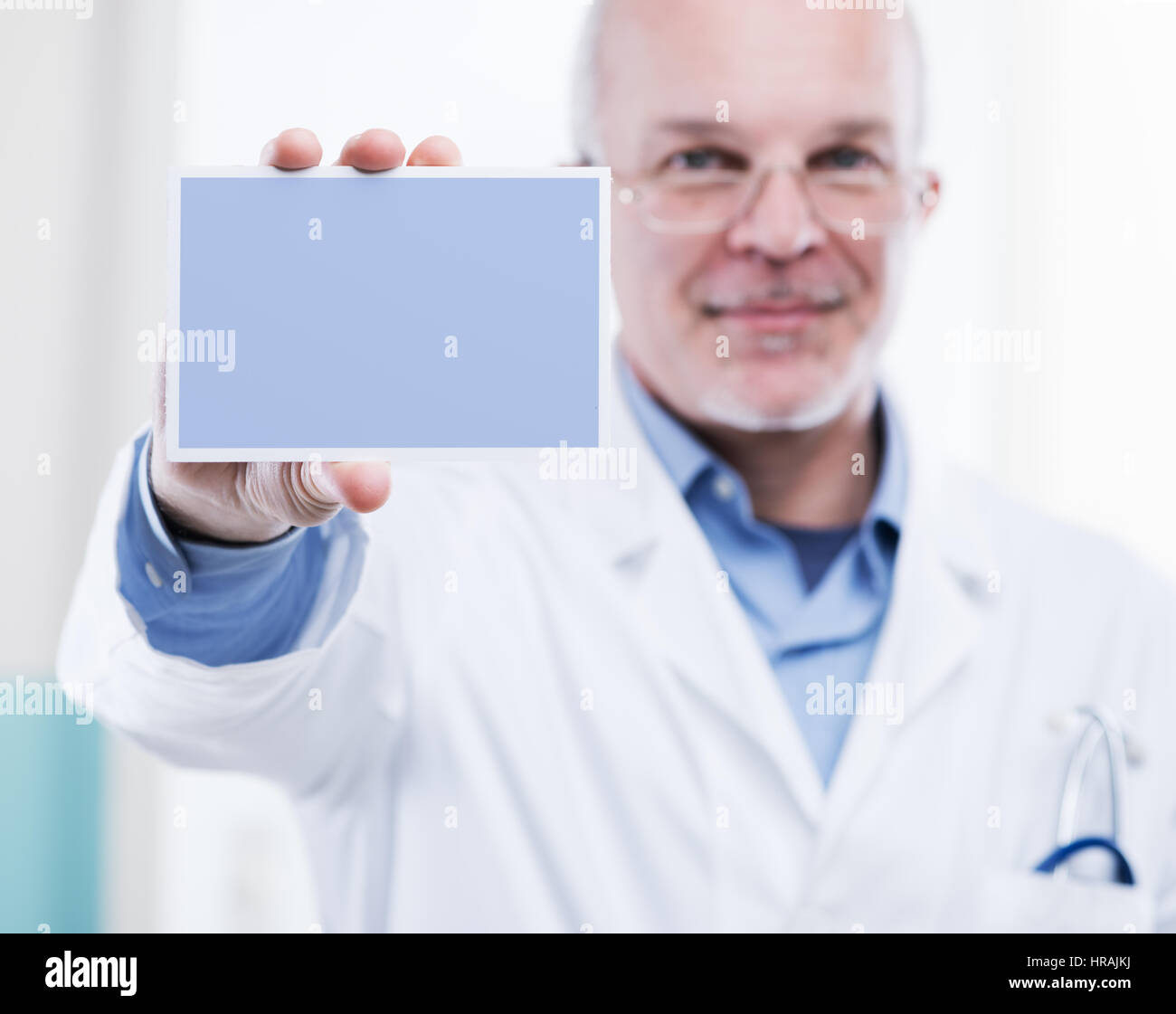 Doctor showing small white sign hi-res stock photography and images - Alamy