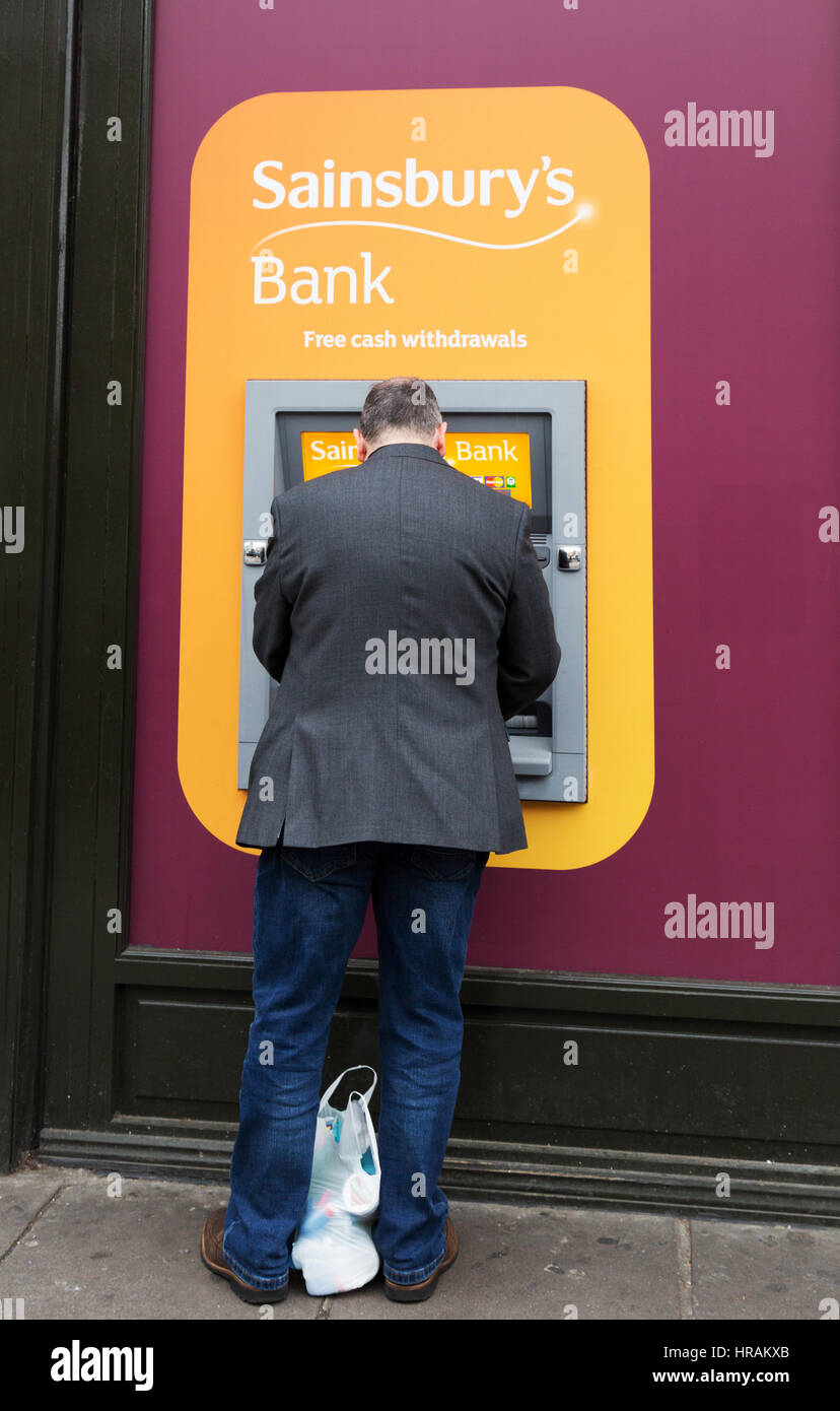 A man using a Sainsburys Bank ATM, London, UK Stock Photo