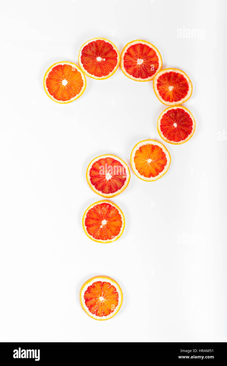 Question mark made from citrus fruit blood oranges on white background