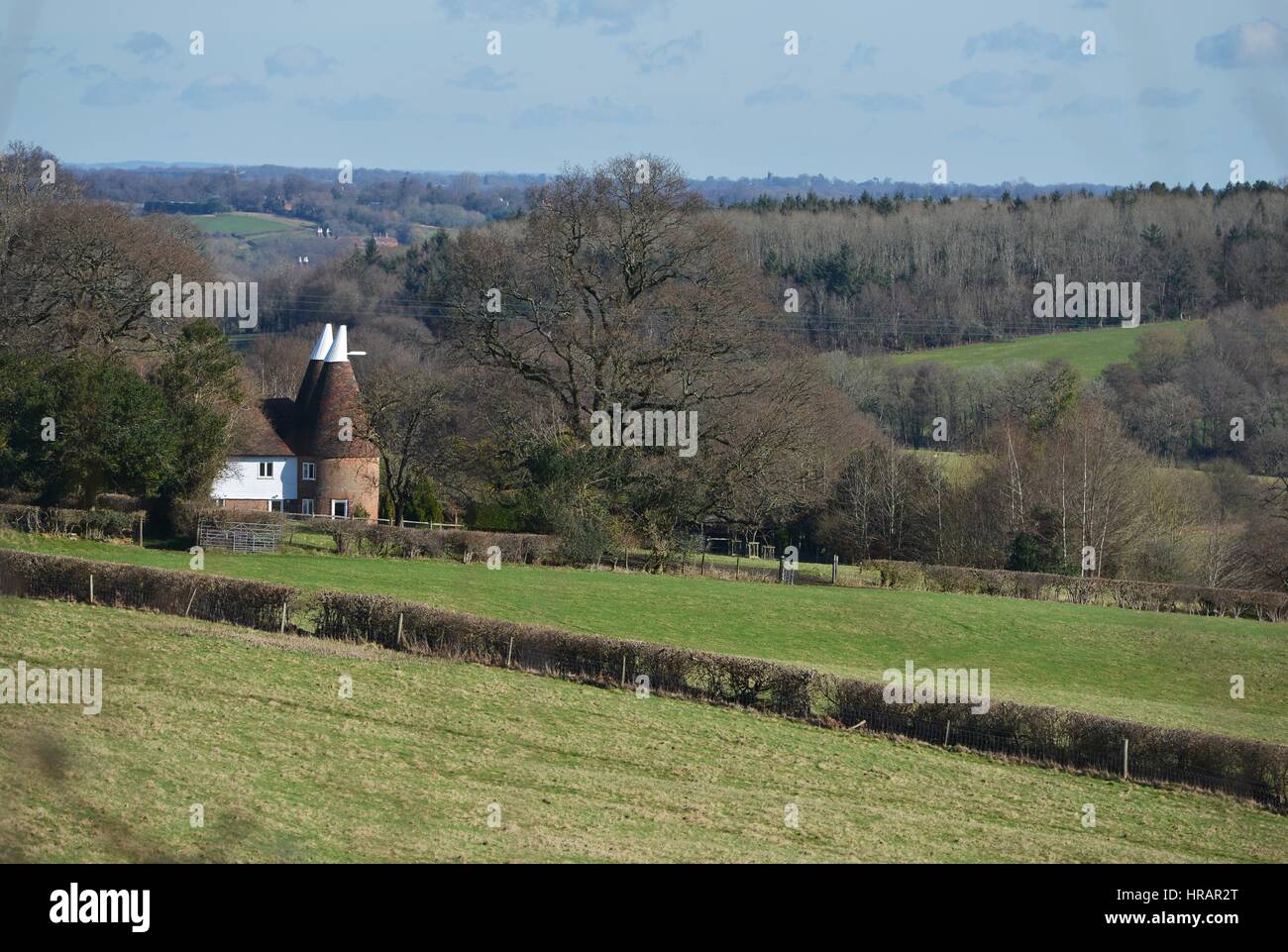 Robertsbridge, East Sussex, UK. 28th February 2017. Bright sunshine and blue sky over a traditional oast house in East Sussex. Credit: Peter Cripps/Alamy Live News Stock Photo