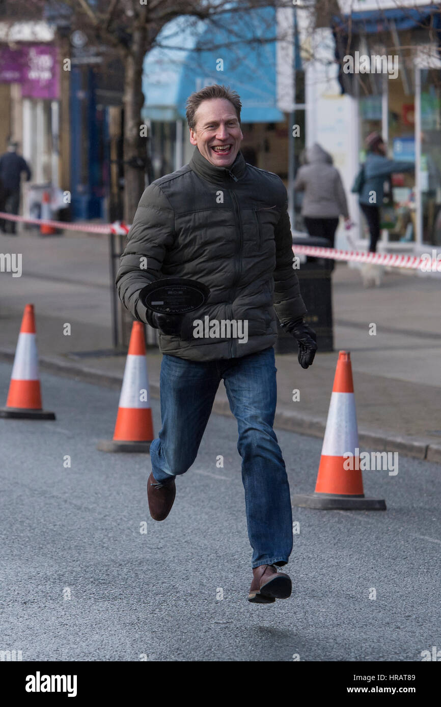 The Grove, Ilkley, West Yorkshire, UK. 28th Feb, 2017. A male competitor is taking part and running in the traditional, annual Ilkley Rotary Pancake Race. Credit: Ian Lamond/Alamy Live News Stock Photo