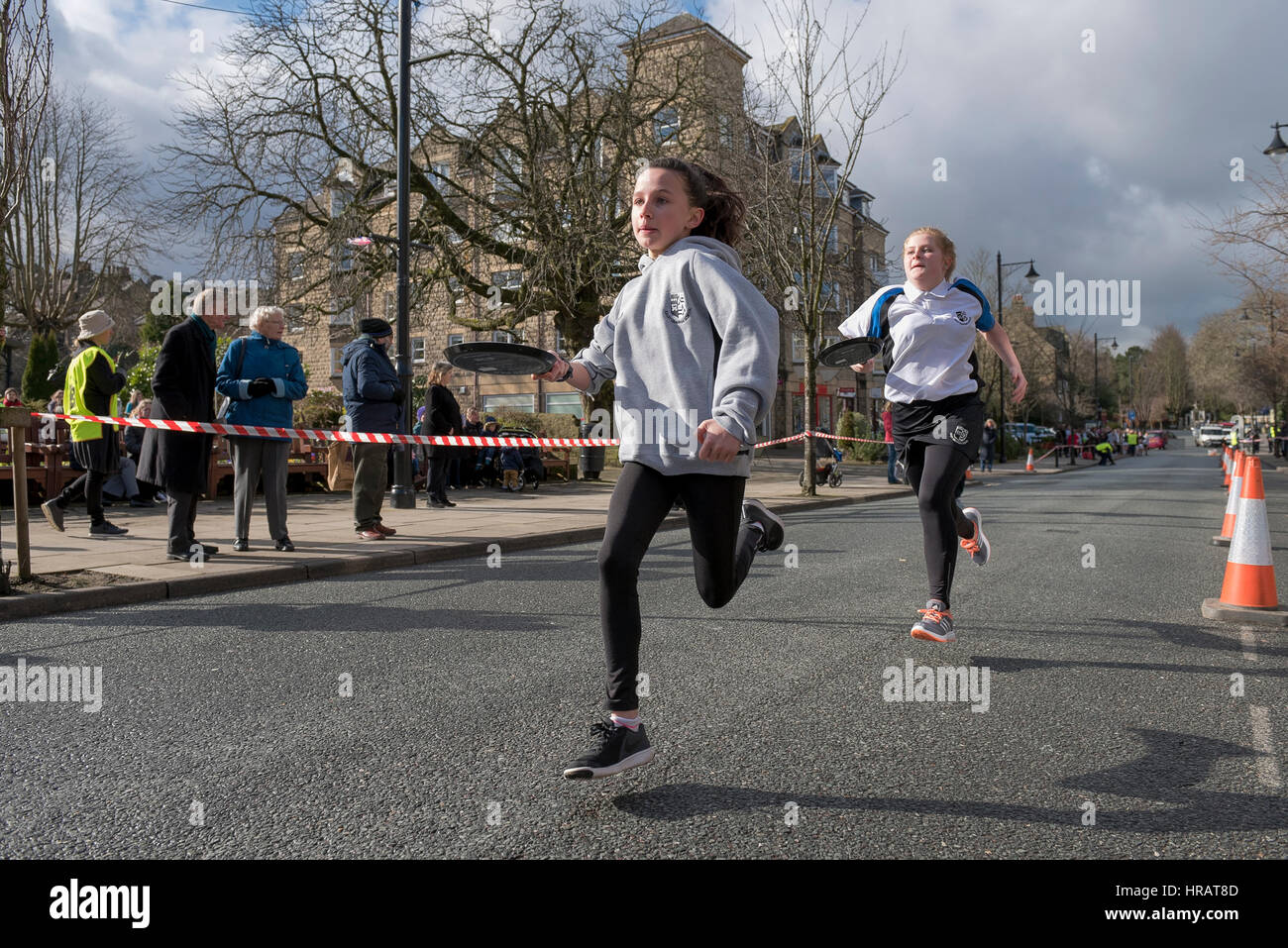 The Grove, Ilkley, West Yorkshire, UK. 28th Feb, 2017. Young competitors (school girls) are taking part and running in the traditional, annual Ilkley Rotary Pancake Race. Credit: Ian Lamond/Alamy Live News Stock Photo
