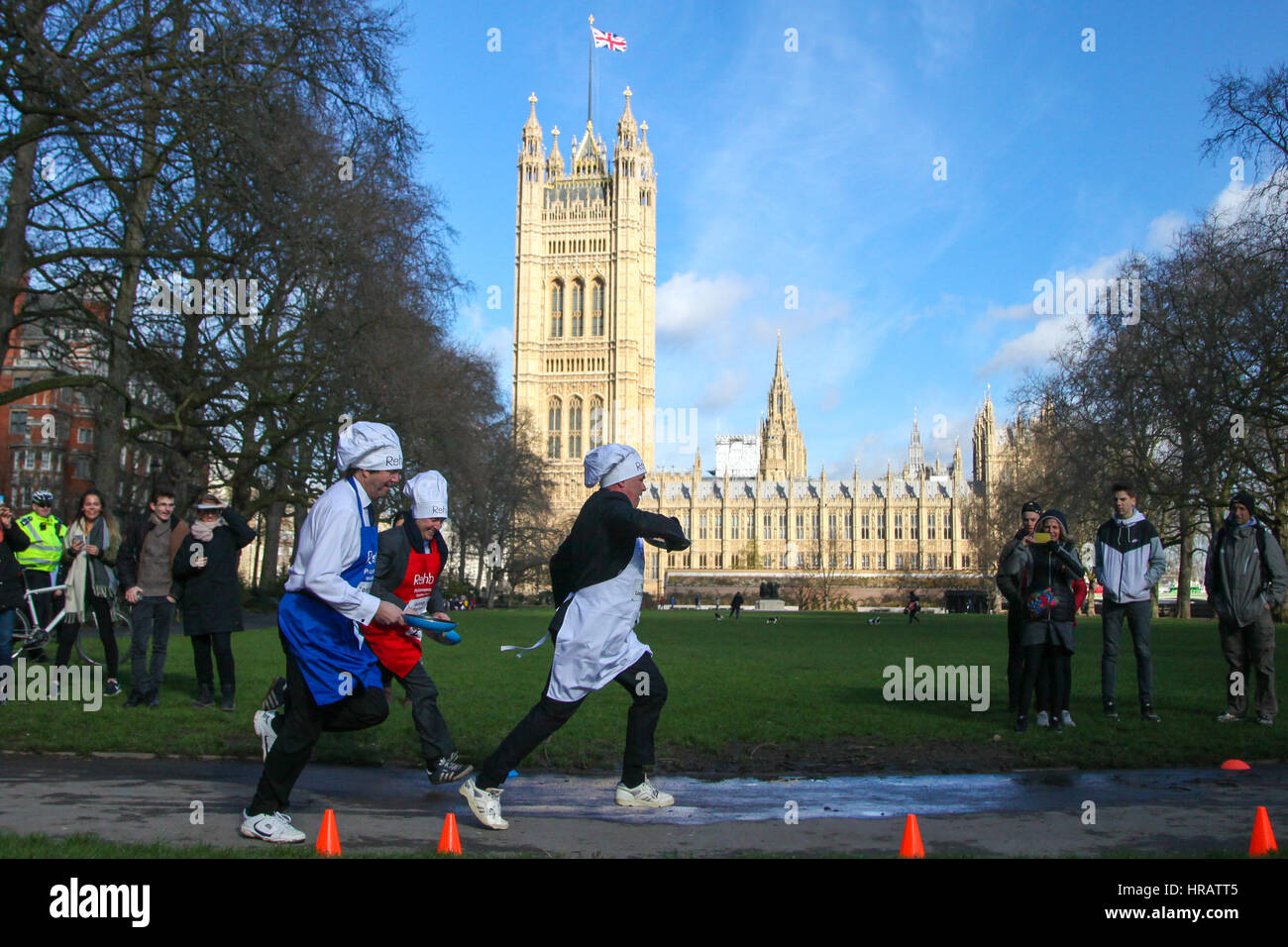 Victoria Tower Gardens, London, UK. 28th Feb, 2017. Tim Loughton, MP for East Worthing and Shoreham, George Parker, Political Editor, Financial Times. Lords, MPs and members of media teams take part in pancake race - celebrating 20 years of flipping for Rehab charity and its work with disabled people. Credit: Dinendra Haria/Alamy Live News Stock Photo
