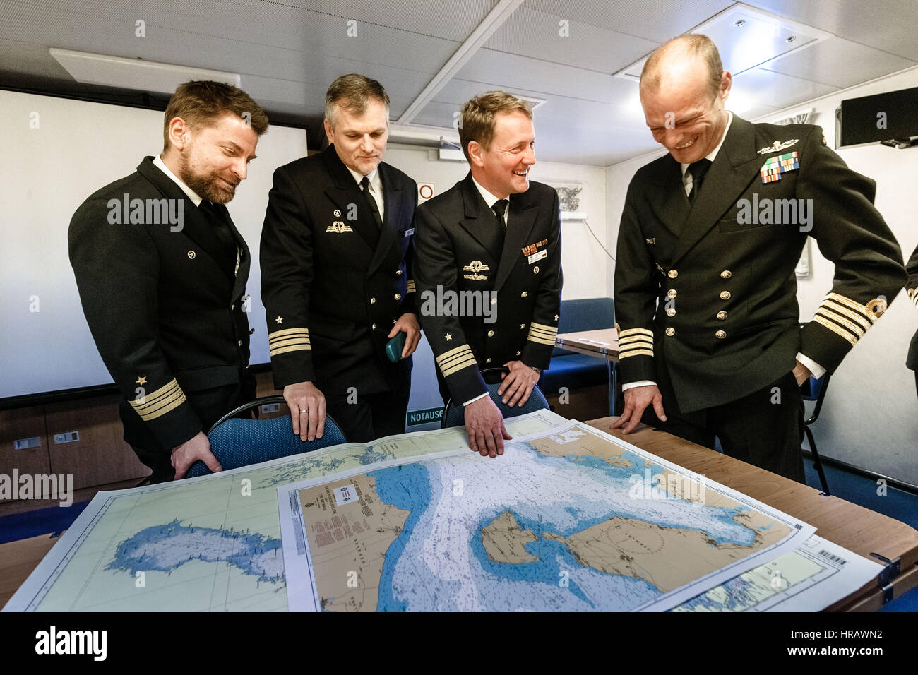 Kiel, Germany. 28th Feb, 2017. Marco Taedcke (l-r), the captain of the German frigate Augsburg, Jobst Berg, captain of the German auxiliary ship Bonn, Volker Herbert Blasche, task for director of the Good Hope VII naval exercise, and Francois Roux, captain of the South African frigate Amatola, on the Bonn in the harbour of Kiel, Germany, 28 February 2017. The joint German-South African naval war game in the Baltic Sea will conclude on the 13.03.17. Photo: Markus Scholz/dpa/Alamy Live News Stock Photo