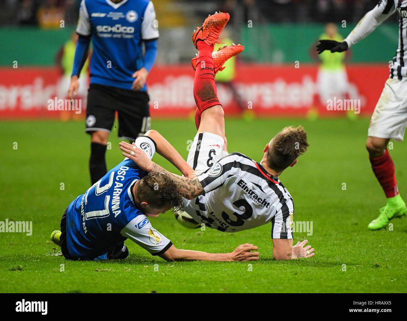 Frankfurt's Guillermo Varela (R)and Arminia's Sebastian Schuppan vie for  the ball during the German Football Association (DFB) Cup quarter final  fixture between Eintracht Frankfurt and Arminia Bielefeld in the  Commerzbank Arena in