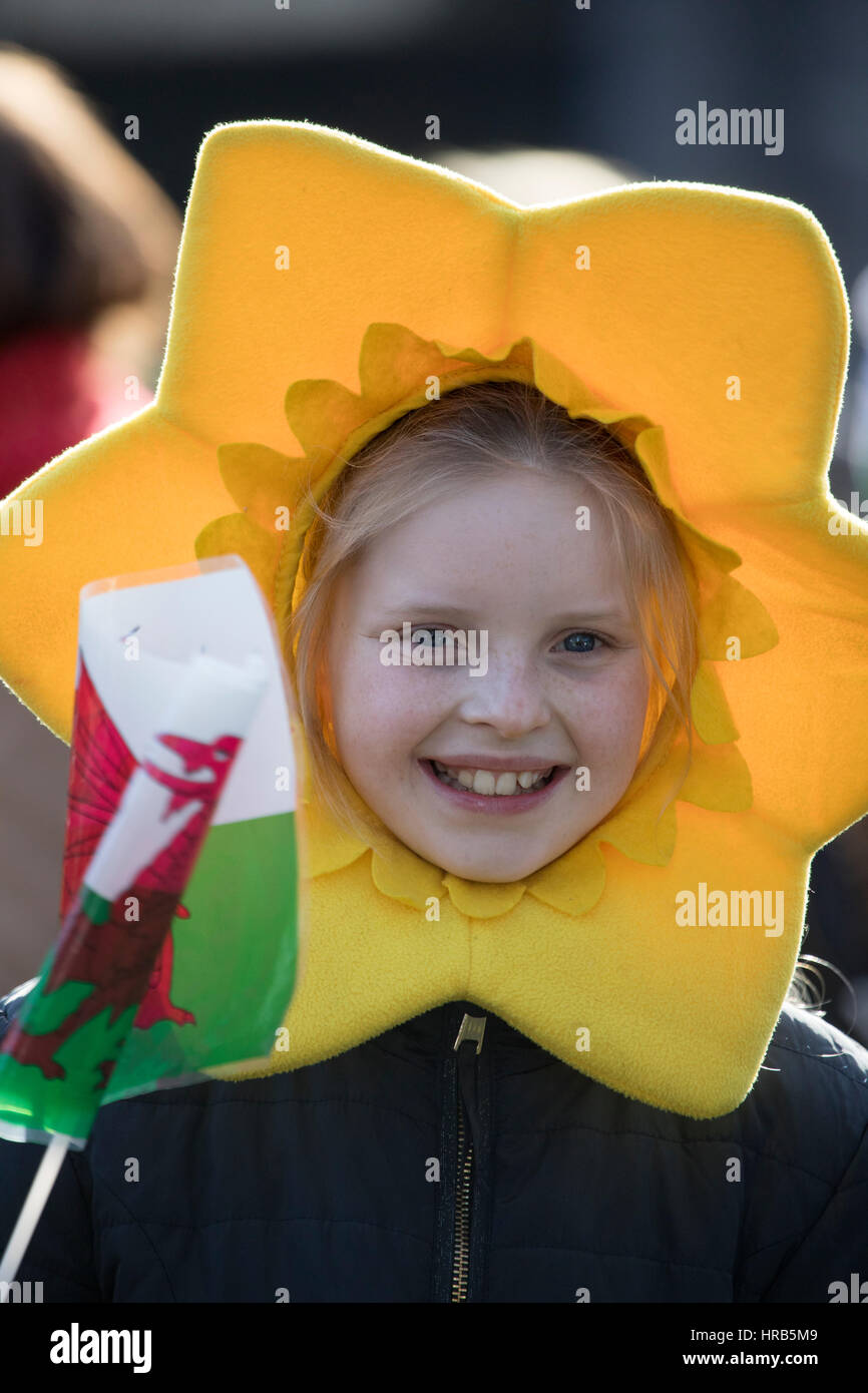 St David's Day celebrations as school children march through the town of Colwyn Bay, North Wales with welsh flags and daffodils Stock Photo