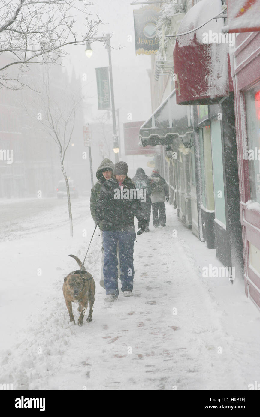 Snowstorm downtown Portland Maine sidewalk pedestrians walking winter storm snow New England USA weather cold ice winter Stock Photo