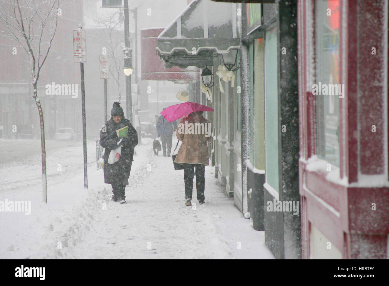 Snowstorm downtown Portland Maine sidewalk pedestrians walking winter storm snow New England USA weather cold ice winter Stock Photo