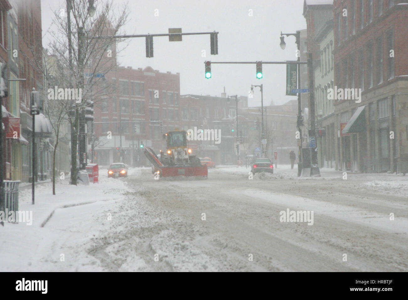 Snowstorm downtown Portland Maine snow plow winter storm snow New England USA weather cold ice winter Stock Photo