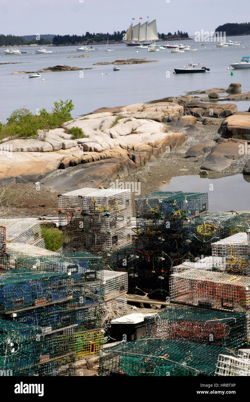 Lobster traps Stonington Harbor Maine boats on moorings three masted schooner windjammer New England USA Stock Photo