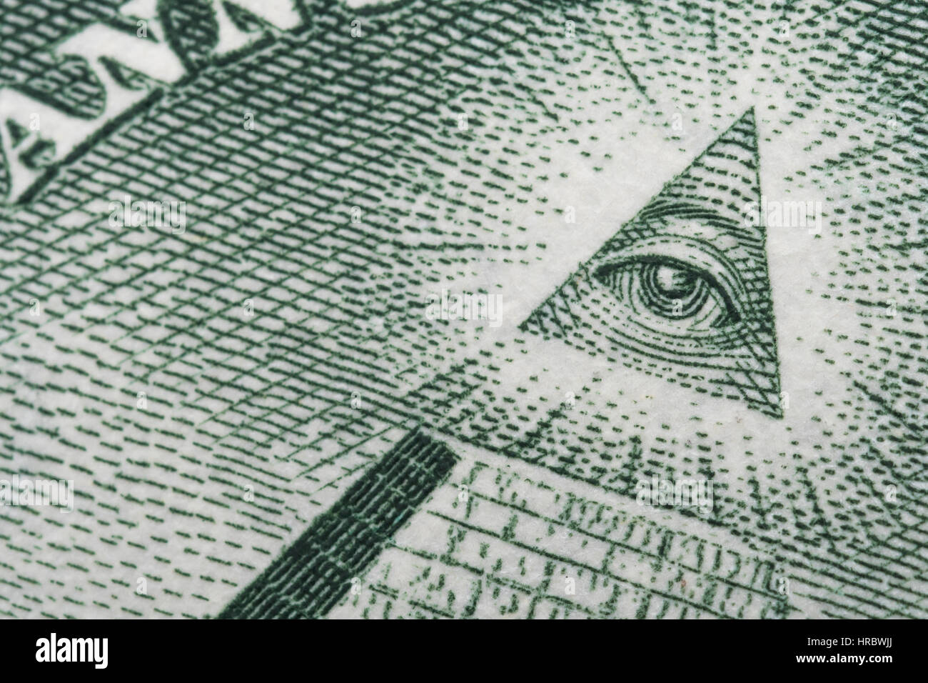 Ultra close up / macro photo of Eye details on a US $1 / One Dollar bill / banknote. Metaphor for US trade / currency / business, one dollar note USA. Stock Photo