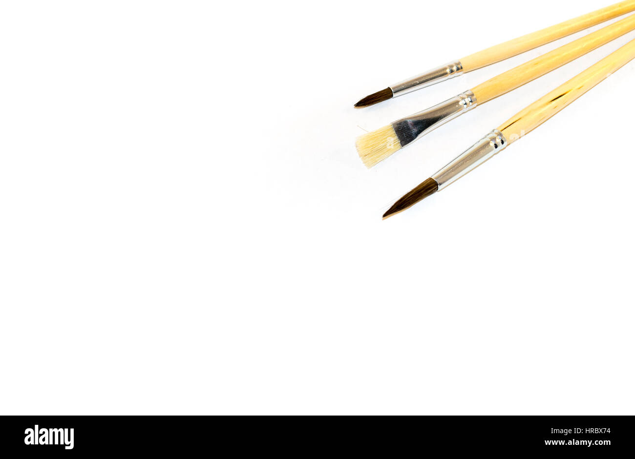 Three paintbrushes isolated on a white background Stock Photo