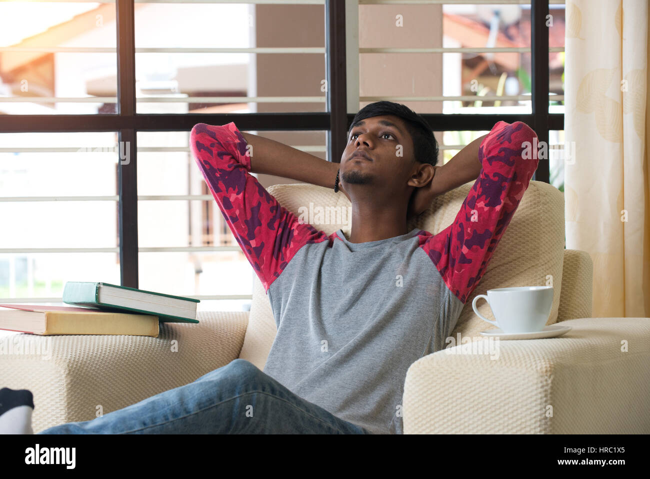 Teen boy relaxing sofa african hi-res stock photography and images - Alamy