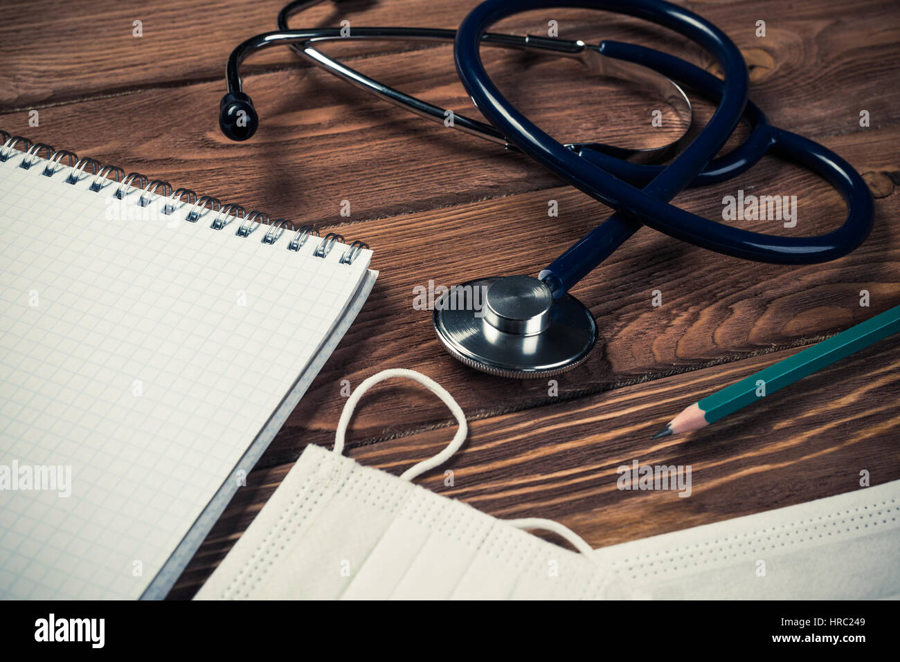 Close view of stethoscope on wooden desk Stock Photo - Alamy