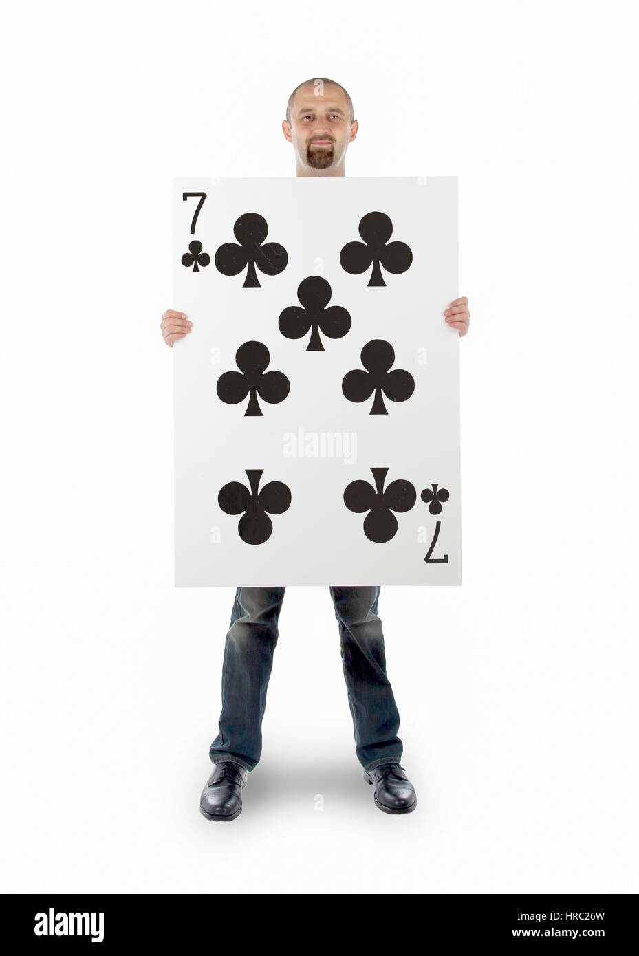 Businessman with large playing card - Seven of clubs Stock Photo