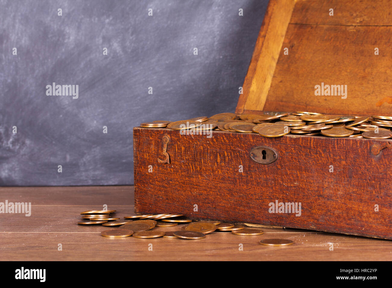 Old wooden chest filled with old copper coins Stock Photo Alamy