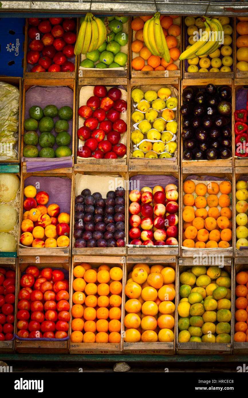 Selection of colorful healthy fresh fruit for sale in wooden boxes on a street market stall in