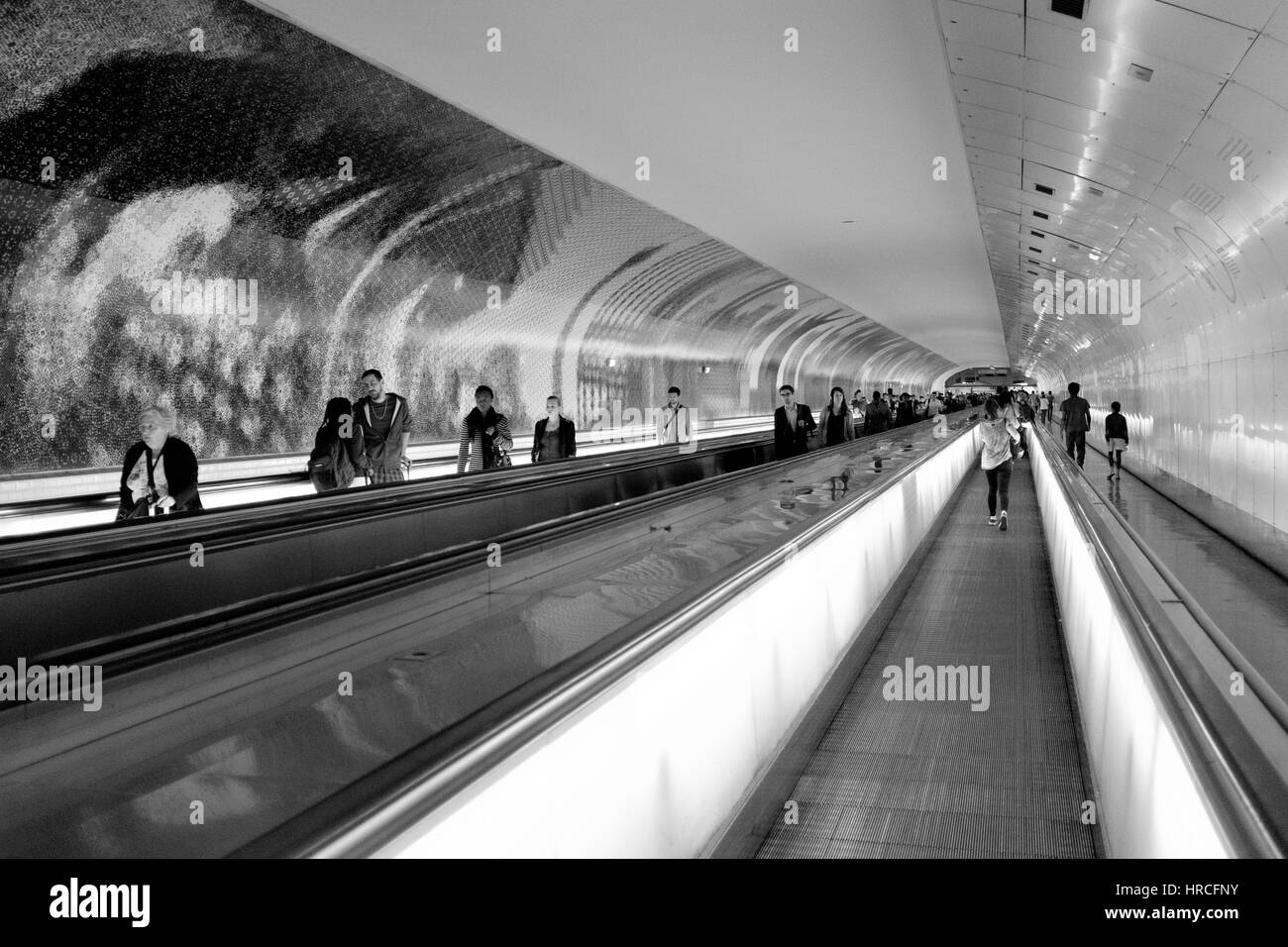 Passengers on conveyor belts at Montparnasse Station in France in a