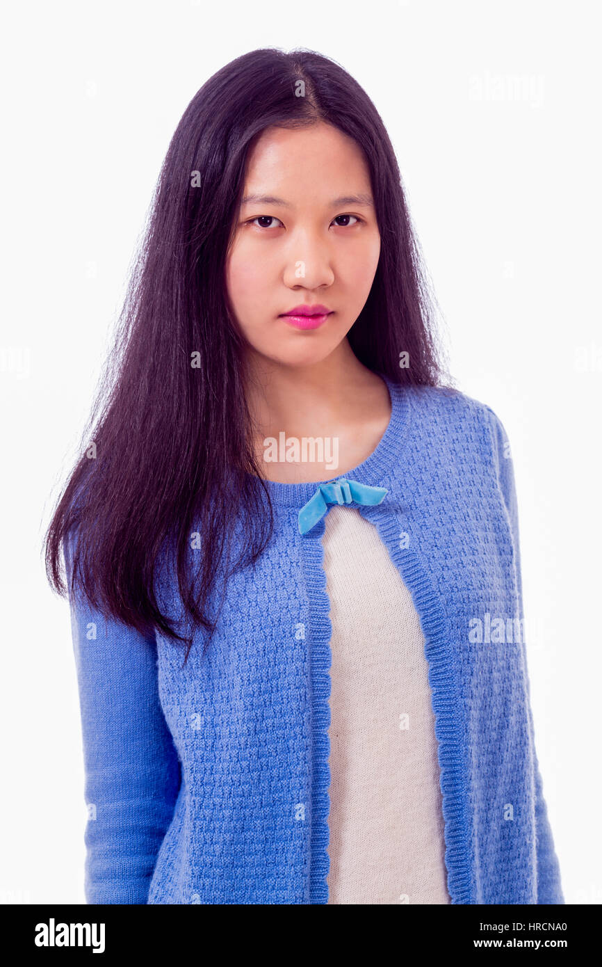 Portrait of Chinese teenage girl looking at camera, serious expression Stock Photo
