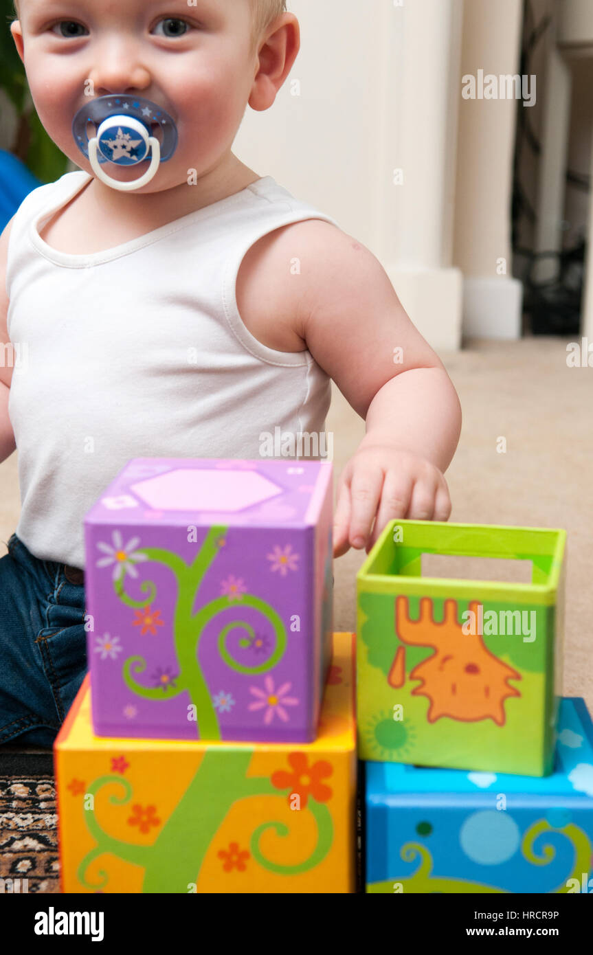 baby playing with blocks to make a tower, happy baby boy Stock Photo