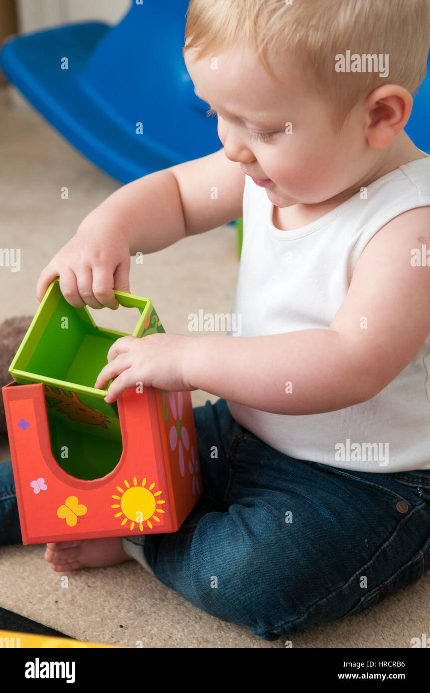 baby playing with blocks to make a tower, happy baby boy Stock Photo