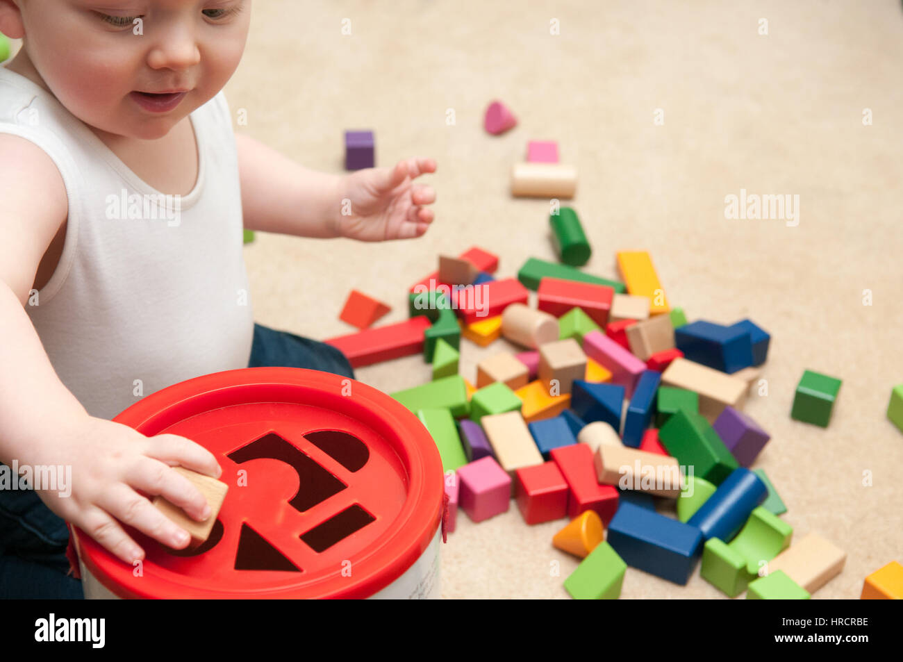baby playing with blocks and sorting shapes Stock Photo