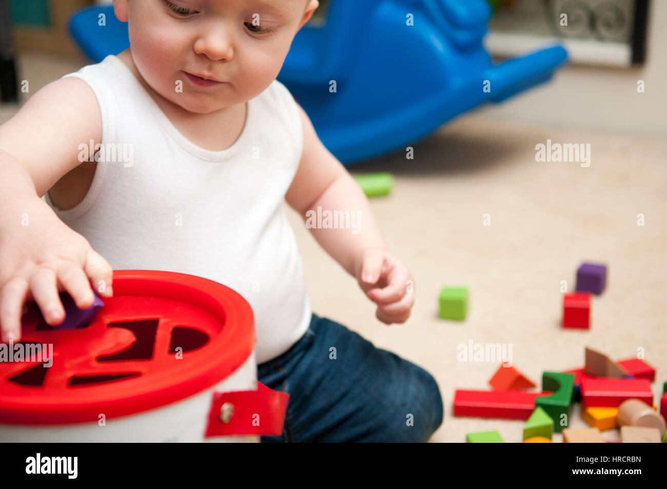 baby playing with blocks and sorting shapes Stock Photo