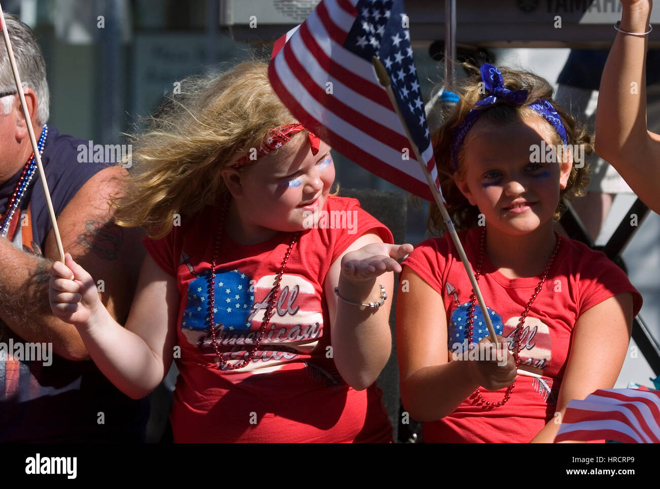 A pair of young girls watching the annual 4th of July parade in Hyannis, Massachusetts on Cape Cod Stock Photo