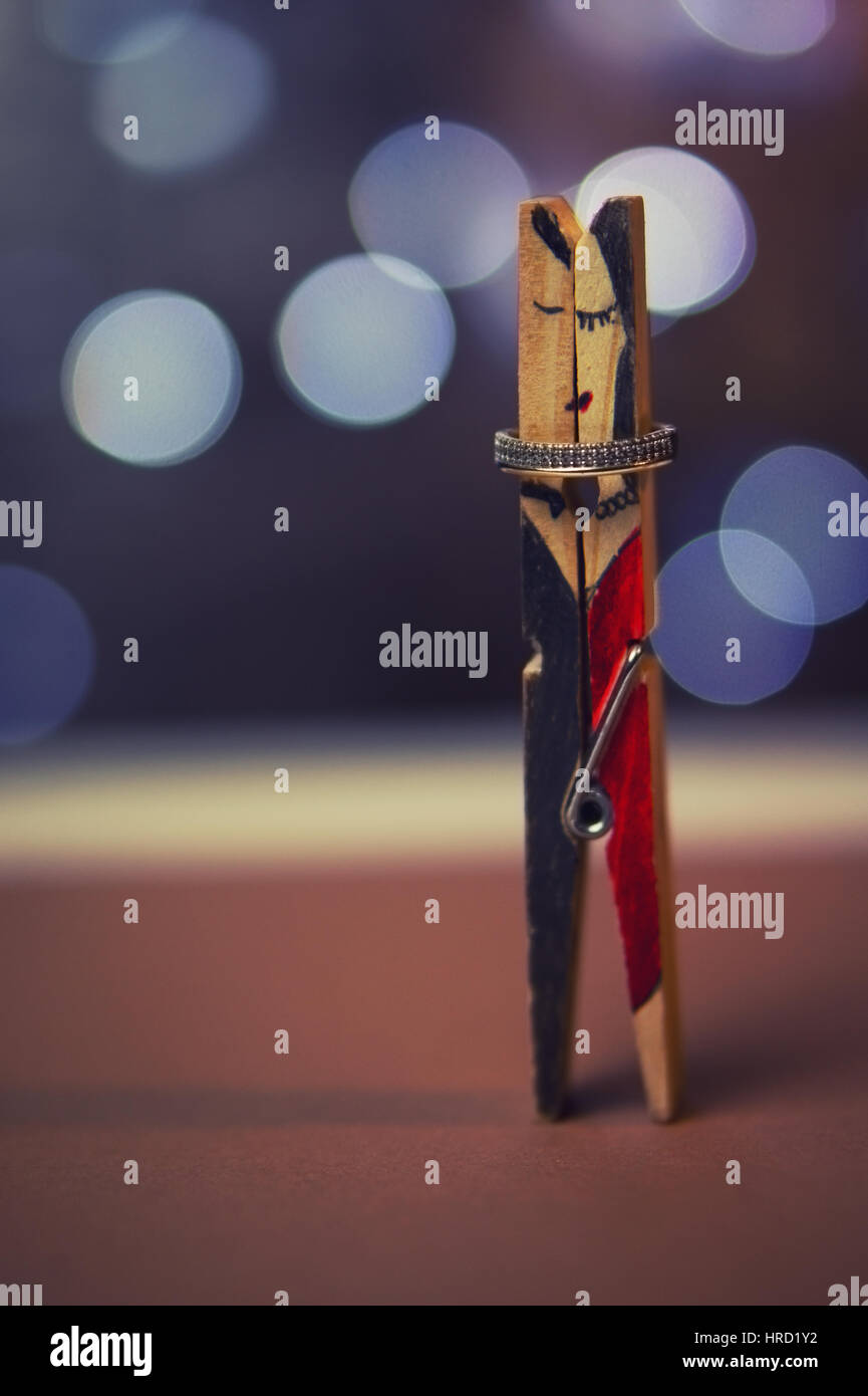 Clothespin couple with a wedding ring. Color effects and custom white