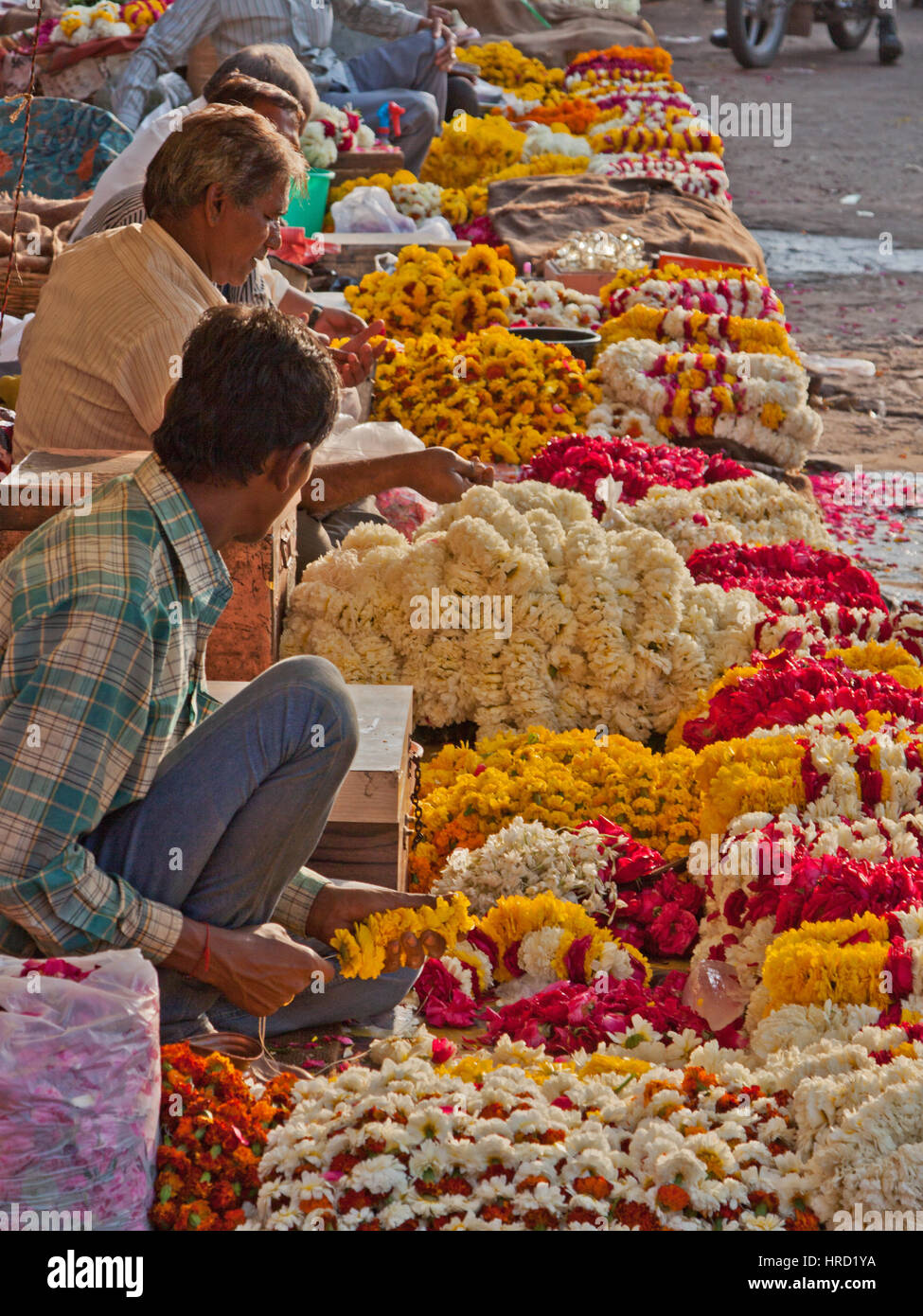 Traders selling flower garlands and petals for worshippers in a nearby Hindu temple in the Tripolia Bazaar district of Jaipur in Rajasthan, India Stock Photo