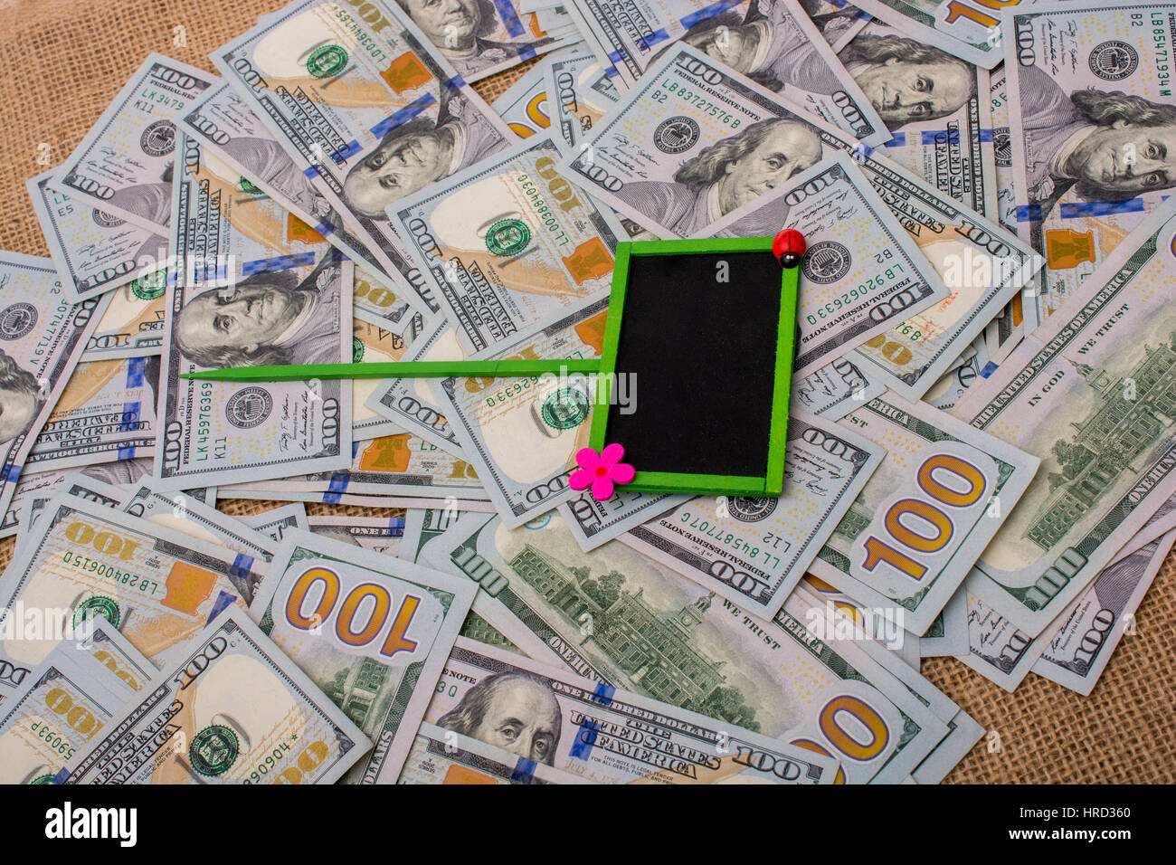 Notice board placed on spread US dollar banknotes Stock Photo - Alamy