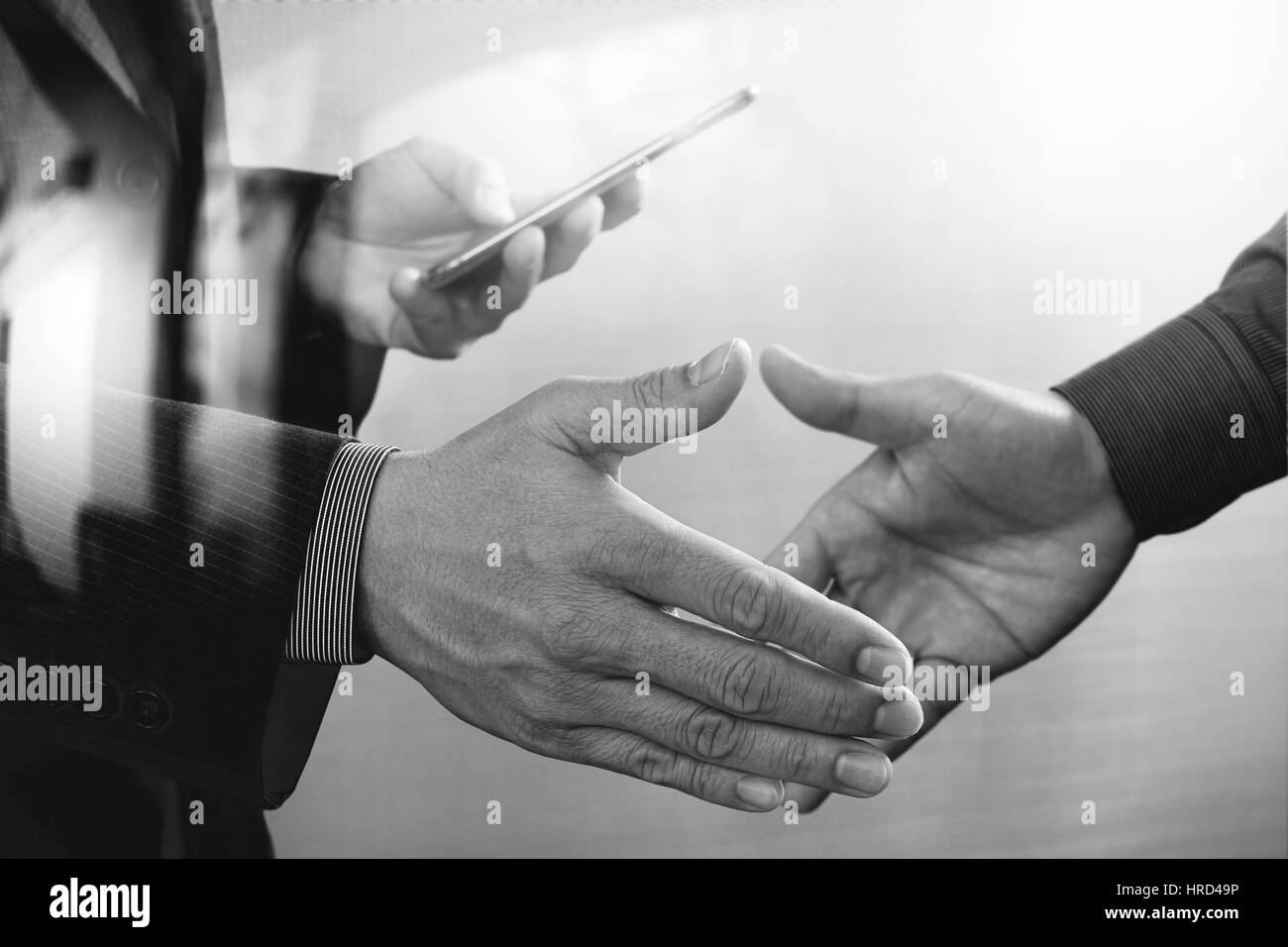 Business partnership meeting concept.photo businessmans handshake. Successful businessmen handshaking after perfect deal.close up,black and white Stock Photo
