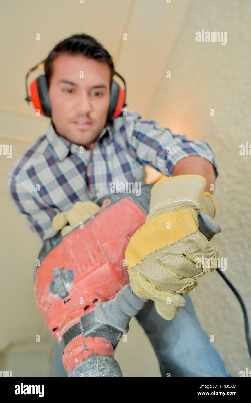 Using a hammer drill on the floor Stock Photo Alamy