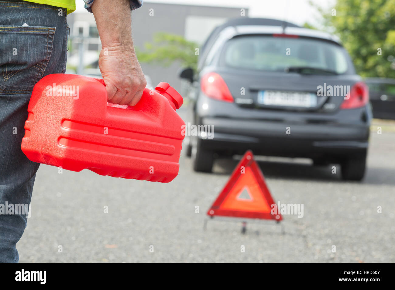 man holding gasoline canister Stock Photo Alamy