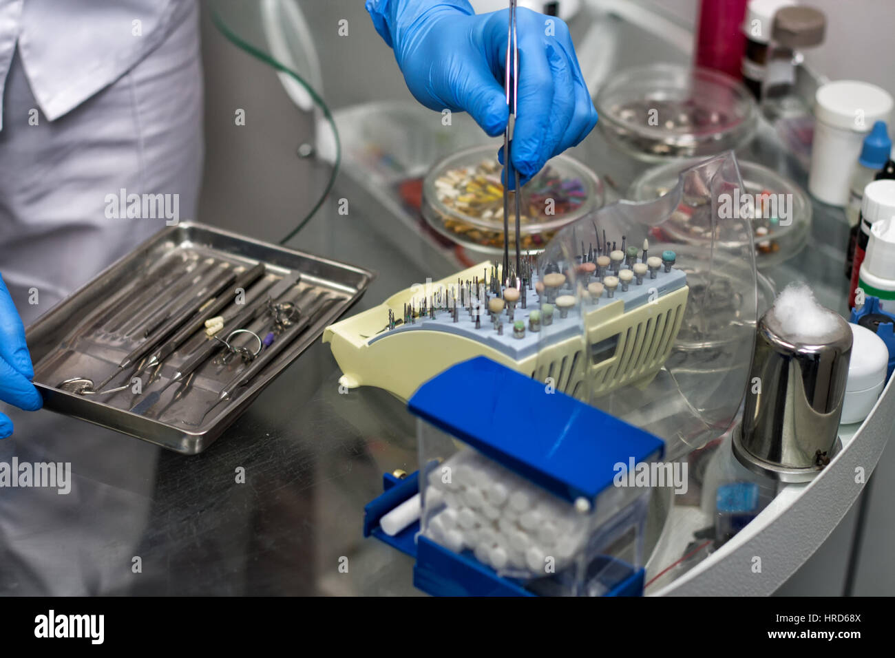 Close-up view of hands of the dentist holding dental instruments and ...