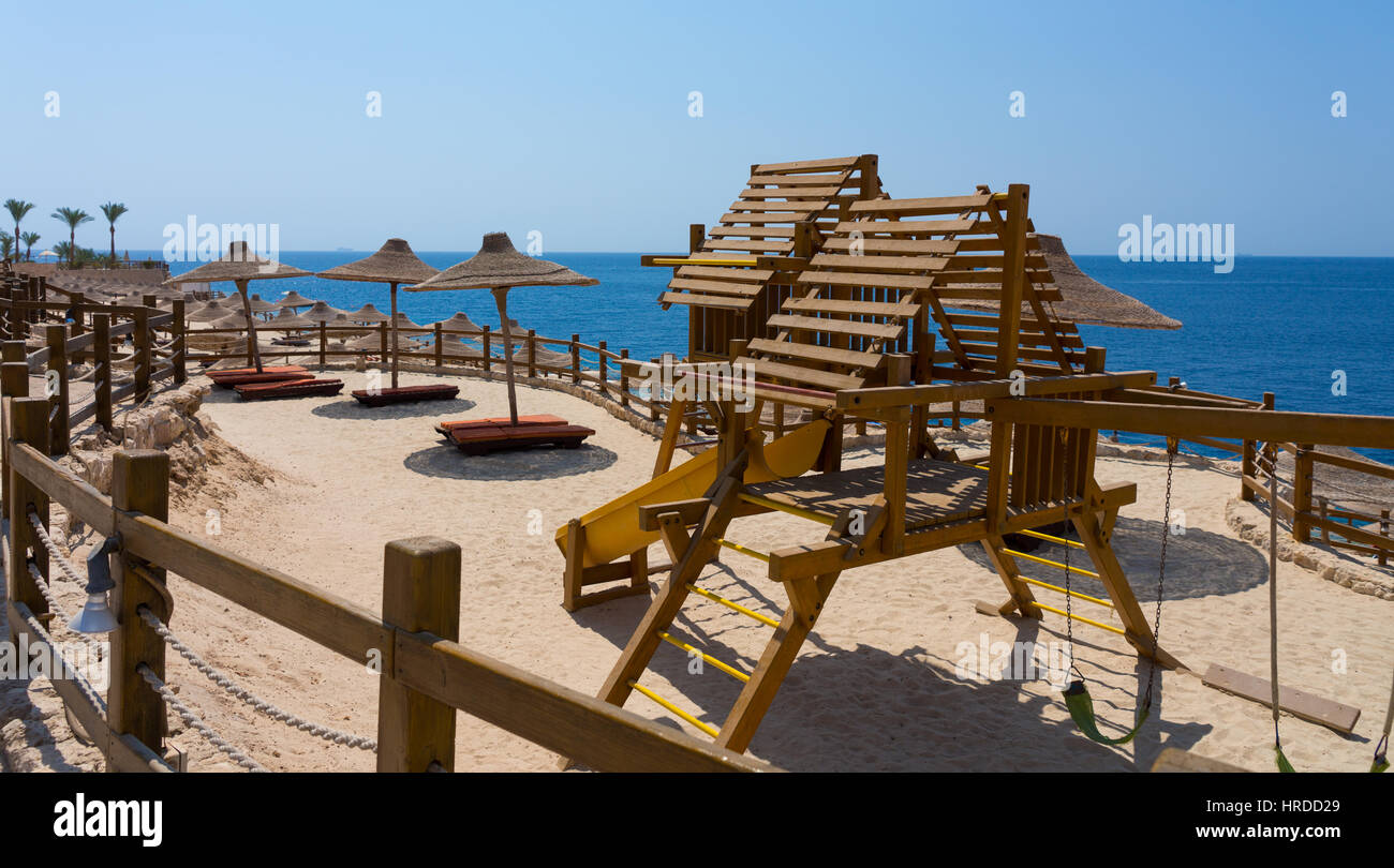 Wooden playground for children on the beach near the sea Stock Photo