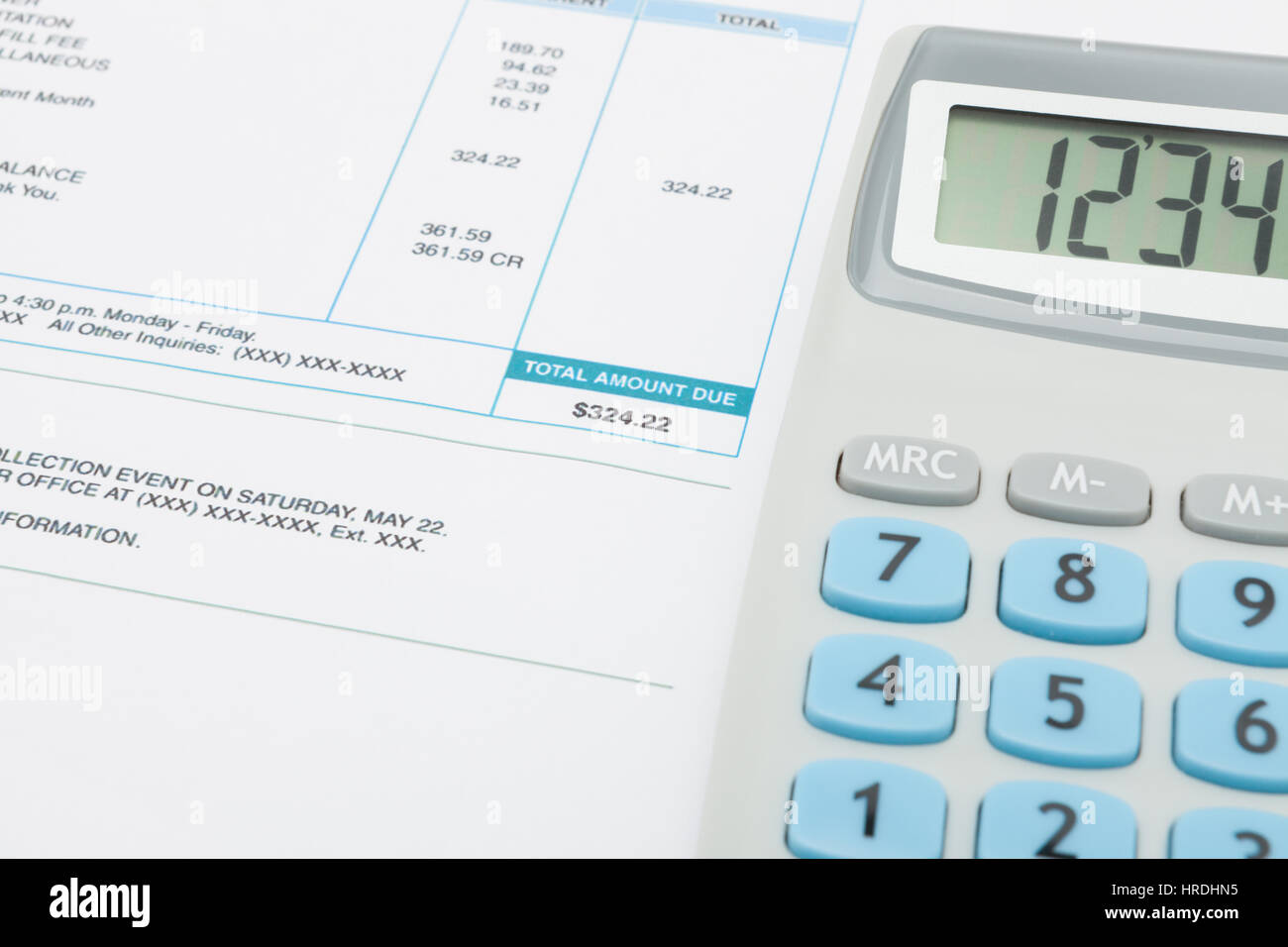 Unpaid utility bill and calculator next to it - close up shot Stock Photo