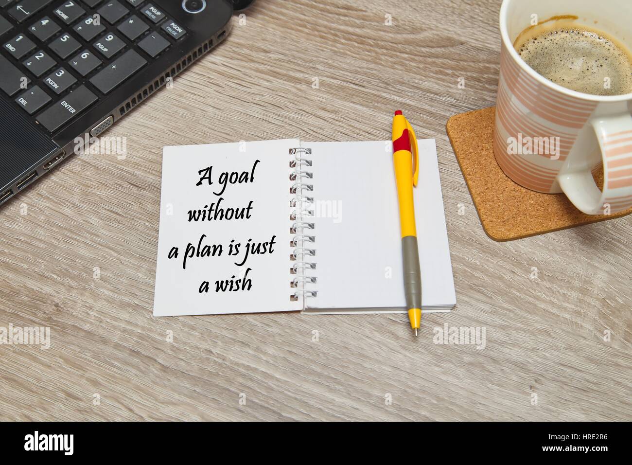 Open notebook with text  and a cup of coffee on wooden background. Stock Photo