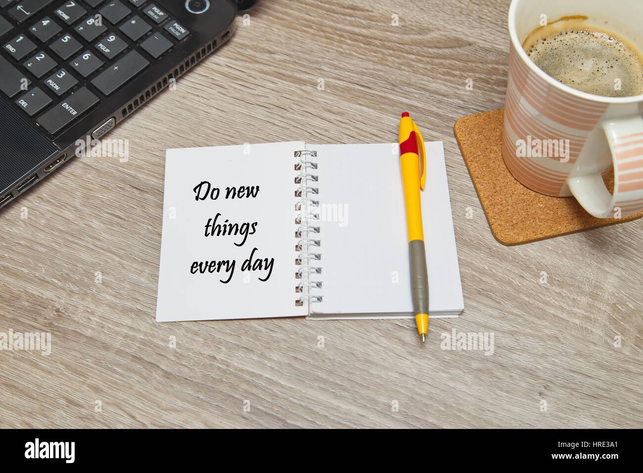 Open notebook with text  and a cup of coffee on wooden background. Stock Photo