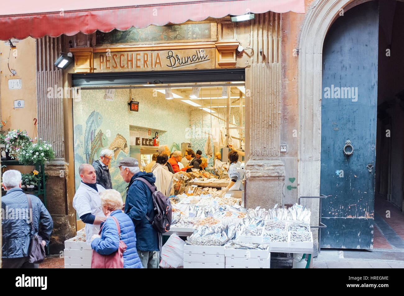 A group of customers at the Pescheria Brunelli in Via Drapperie in Bologna, Italy. Stock Photo