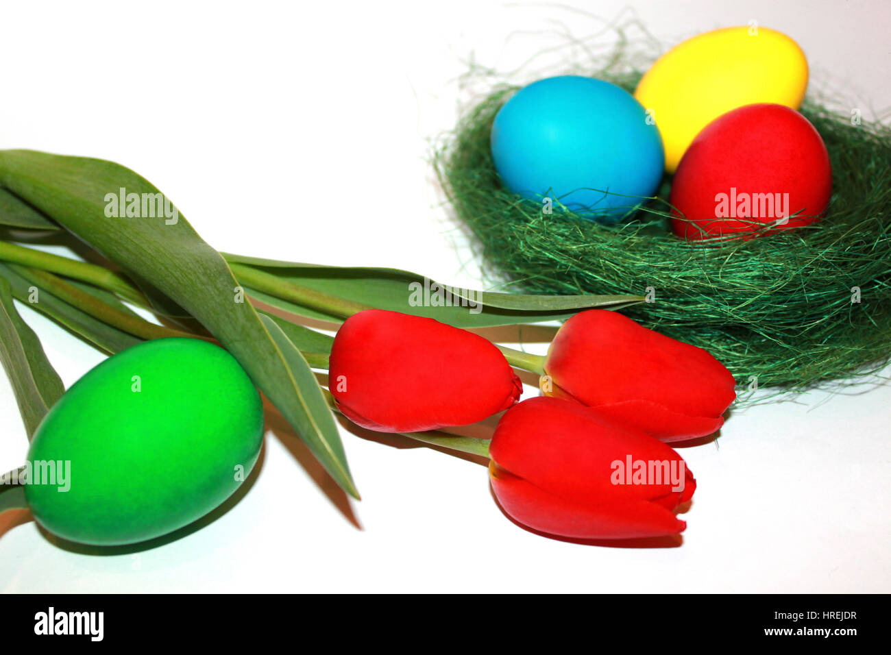 Colored easter eggs and red tulips Stock Photo - Alamy