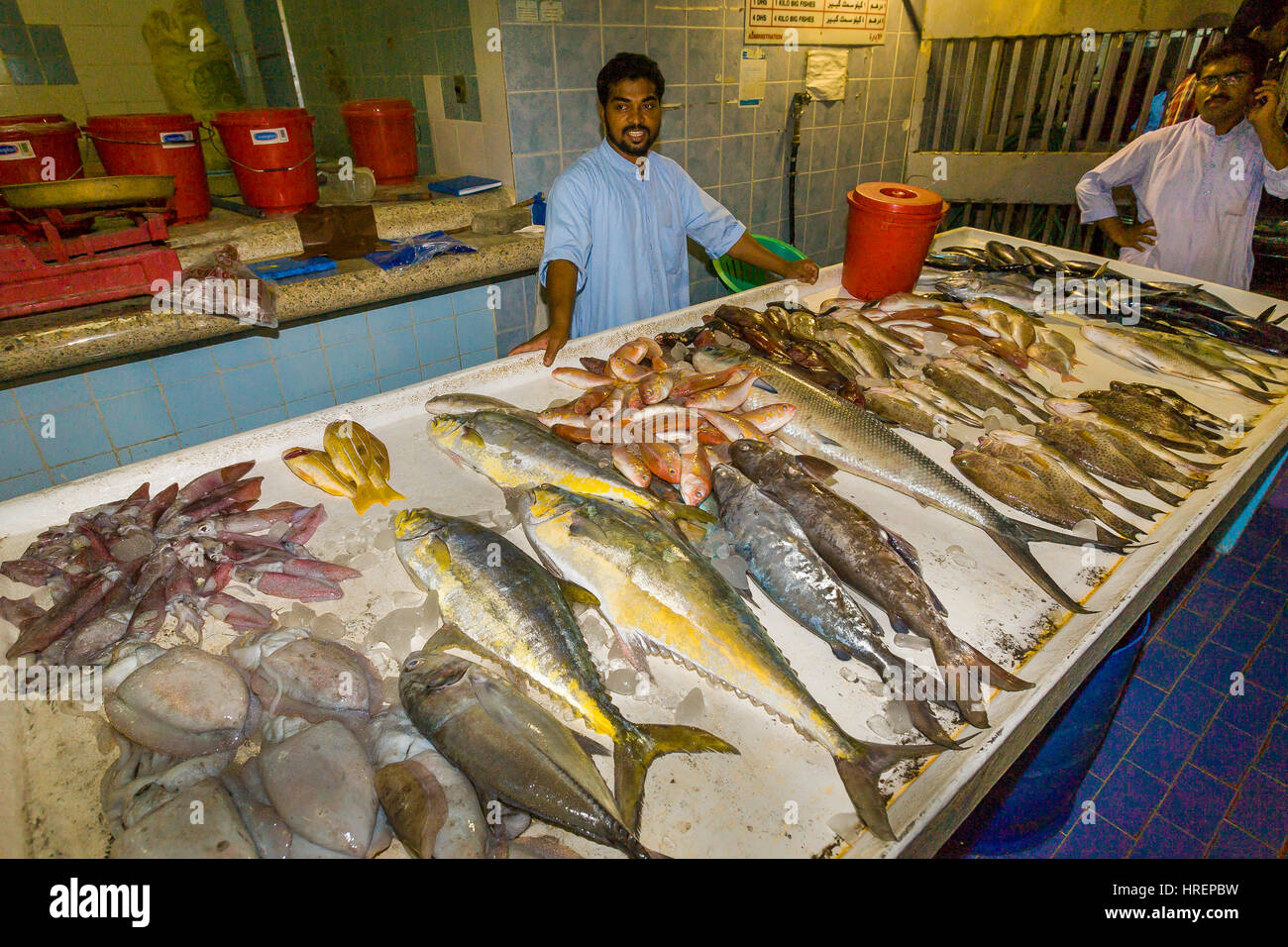 FUJAIRAH, UNITED ARAB EMIRATES Vendor and seafood on display at Fish