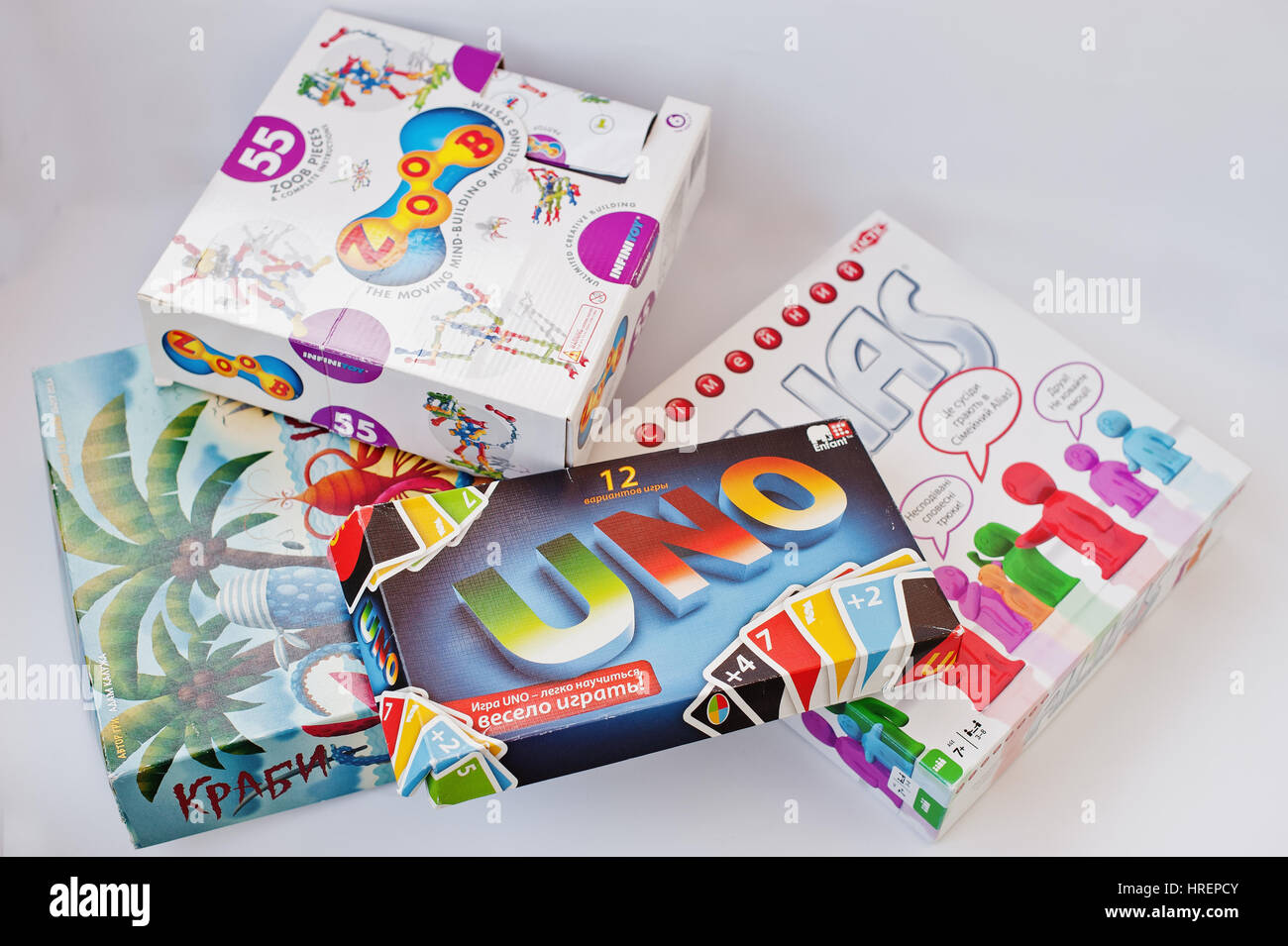 Hai, Ukraine - March 1, 2017: Different board games boxes such as Alias, Uno, Zoob, Crabs isolated on white. Stock Photo