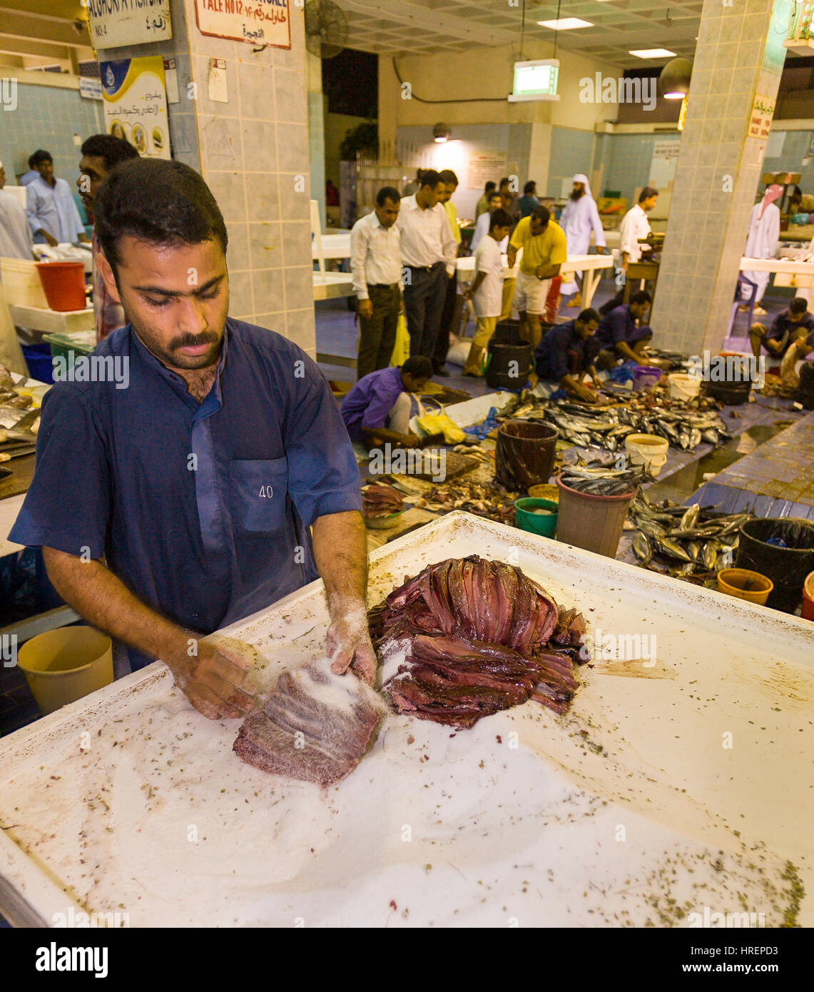 FUJAIRAH, UNITED ARAB EMIRATES Salting fish at seafood market Stock