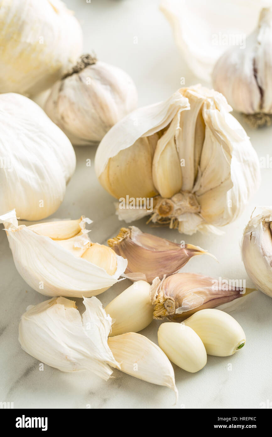 Peeled fresh garlic on kitchen table. Stock Photo