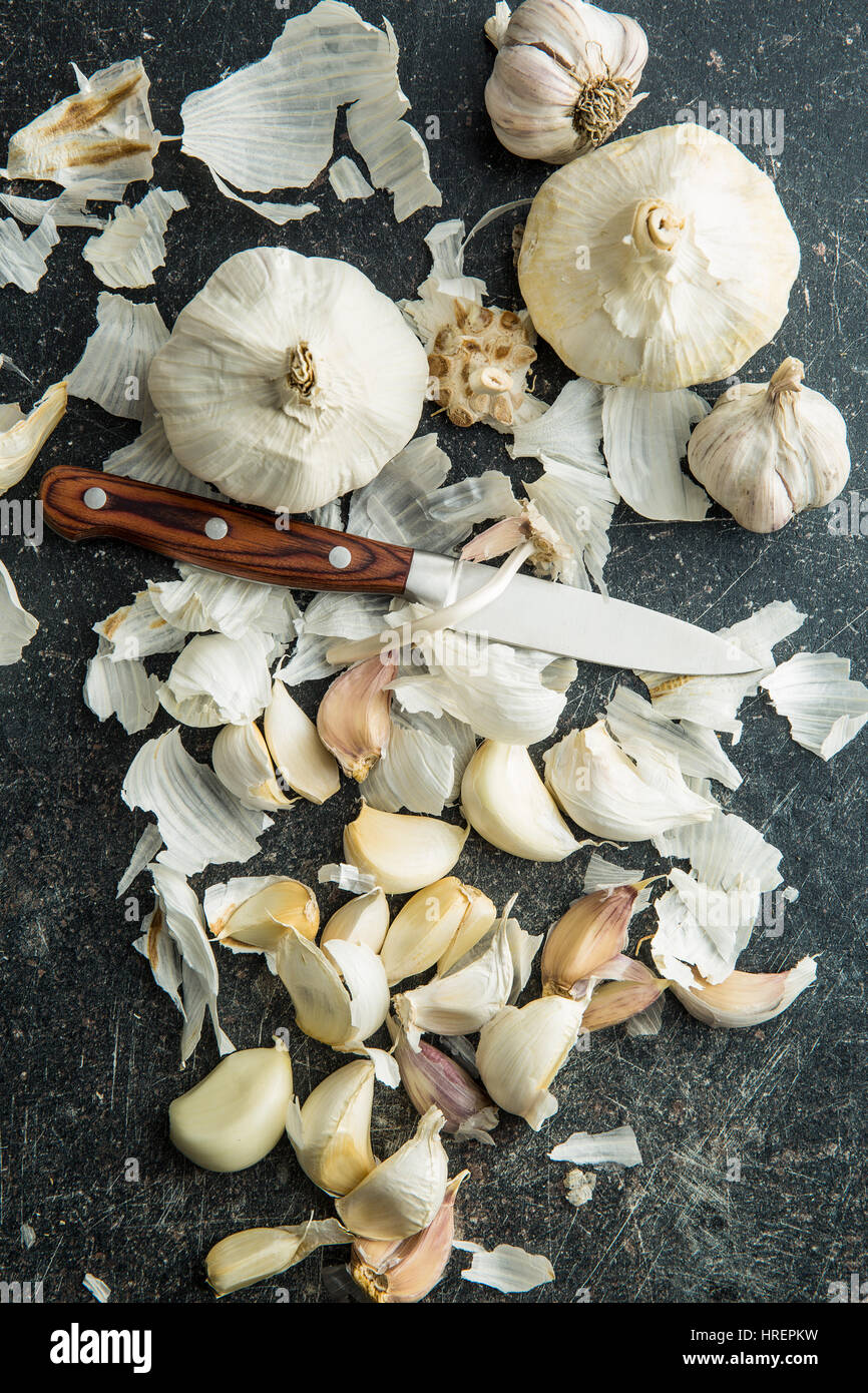 Peeled fresh garlic on kitchen table. Top view. Stock Photo